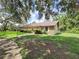 Ranch style home with stone facade and well maintained lawn at 11307 Sandpine Rd, Riverview, FL 33569