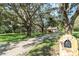 Charming exterior view of a home with a tree-lined driveway and well-maintained lawn at 11307 Sandpine Rd, Riverview, FL 33569