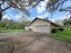 View of a cream-colored house with an attached two-car garage and concrete driveway at 11307 Sandpine Rd, Riverview, FL 33569