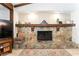 Close-up of the living room's beautiful stone fireplace with wood mantle at 11307 Sandpine Rd, Riverview, FL 33569