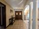 Inviting foyer with decorative double doors, tile flooring, and classic architectural columns at 11307 Sandpine Rd, Riverview, FL 33569