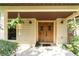 Inviting front door with hanging plants, stone accents and attractive design at 11307 Sandpine Rd, Riverview, FL 33569