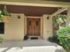 A covered front entryway with decorative double doors, potted plants, and sconce lighting at 11307 Sandpine Rd, Riverview, FL 33569