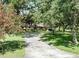 Charming home with a long driveway and lush front yard surrounded by trees at 11307 Sandpine Rd, Riverview, FL 33569