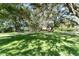 Lush front yard with mature trees and circular driveway at 11307 Sandpine Rd, Riverview, FL 33569