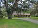 Ranch style home with circular driveway, mature trees and professional landscaping at 11307 Sandpine Rd, Riverview, FL 33569
