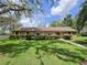 Charming ranch home featuring a stone facade and manicured front lawn at 11307 Sandpine Rd, Riverview, FL 33569