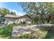 Spacious garage with a long driveway, mature trees, and ample parking space at 11307 Sandpine Rd, Riverview, FL 33569
