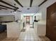 Efficient kitchen with white cabinets, an island with bar seating, and connection to living areas at 11307 Sandpine Rd, Riverview, FL 33569