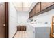 Convenient laundry room featuring a washer, dryer, and ample storage at 11307 Sandpine Rd, Riverview, FL 33569
