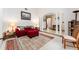 Cozy living room featuring a red sofa, area rug, and bright white columns at 11307 Sandpine Rd, Riverview, FL 33569