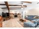 Spacious living room with stone fireplace, wood beams and tile flooring at 11307 Sandpine Rd, Riverview, FL 33569