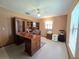 Spacious home office features a built-in desk, cabinetry and large window at 11307 Sandpine Rd, Riverview, FL 33569