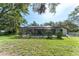 An expansive backyard features a screened-in pool, lush landscaping, and ample room at 11307 Sandpine Rd, Riverview, FL 33569