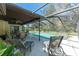 Inviting screened-in pool area with lounge chairs and dining set, perfect for outdoor entertainment at 11307 Sandpine Rd, Riverview, FL 33569