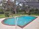 Inviting in-ground pool with screened enclosure, patio and mature landscaping at 11307 Sandpine Rd, Riverview, FL 33569