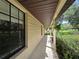 A covered porch featuring views of the front yard with lots of shrubbery and a large window at 11307 Sandpine Rd, Riverview, FL 33569