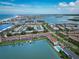 Beautiful aerial view of waterfront condominiums with boat docks and a community pool by the bay at 12132 Capri S Cir, Treasure Island, FL 33706