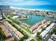 Aerial view of the waterfront community, proximity to the beach, and waterway access at 12132 Capri S Cir, Treasure Island, FL 33706