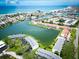 A scenic aerial view of waterfront condos along a tranquil canal near the ocean and beach at 12132 Capri S Cir, Treasure Island, FL 33706
