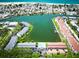 Aerial view of the community on the bay with beach access, a pool, and manicured landscaping at 12132 Capri S Cir, Treasure Island, FL 33706