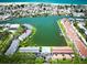 Aerial view of condos, pool, and boat docks on a scenic waterway, perfect for waterfront living at 12132 Capri S Cir, Treasure Island, FL 33706