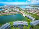 Breathtaking aerial view of waterfront condos with manicured lawns and scenic views of the bay and beach at 12132 Capri S Cir, Treasure Island, FL 33706