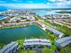Aerial view of waterfront condos with a pool and boat docks, showcasing the community's beautiful bay setting at 12132 Capri S Cir, Treasure Island, FL 33706