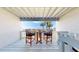 Outdoor balcony featuring a table and chairs and a view of the community waterway and palm trees at 12132 Capri S Cir, Treasure Island, FL 33706