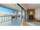 Balcony view with seating, overlooking waterfront and palm trees at 12132 Capri S Cir, Treasure Island, FL 33706