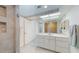 Bathroom featuring a large, seamless glass shower with decorative tile and a vanity at 12132 Capri S Cir, Treasure Island, FL 33706