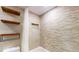 Modern bathroom with a shower-tub combination, tiled walls, and shelving for storage at 12132 Capri S Cir, Treasure Island, FL 33706