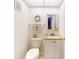 Neat half bathroom with a granite sink and tasteful decorations at 12132 Capri S Cir, Treasure Island, FL 33706
