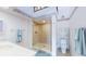 Bright bathroom featuring a seamless glass shower with decorative tile and a modern vanity at 12132 Capri S Cir, Treasure Island, FL 33706