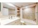 Well-lit bathroom featuring modern fixtures, a shower-tub combination, and ample vanity space at 12132 Capri S Cir, Treasure Island, FL 33706