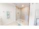 Bright bathroom featuring a seamless glass shower with decorative tile at 12132 Capri S Cir, Treasure Island, FL 33706