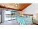 Relaxing bedroom with a wood-paneled ceiling and a balcony overlooking the water at 12132 Capri S Cir, Treasure Island, FL 33706
