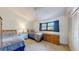 Comfortable bedroom with twin beds, natural light, and ample storage space with dresser and closet at 12132 Capri S Cir, Treasure Island, FL 33706