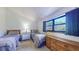 Inviting bedroom featuring twin beds, natural light from a window, and warm, inviting décor at 12132 Capri S Cir, Treasure Island, FL 33706