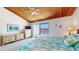 Bright bedroom with vaulted ceilings, waterfront balcony and coastal-themed decor at 12132 Capri S Cir, Treasure Island, FL 33706