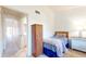 Cozy bedroom featuring a twin bed, wardrobe, and adjacent bathroom for added convenience at 12132 Capri S Cir, Treasure Island, FL 33706