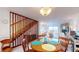 Dining area with a table and chairs and a view of the living room and staircase at 12132 Capri S Cir, Treasure Island, FL 33706
