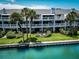 Exterior of the condo showcases balconies, waterfront views, and well-maintained landscaping at 12132 Capri S Cir, Treasure Island, FL 33706