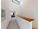 Bright hallway featuring neutral carpet, white walls, and natural wood accents, leading to additional rooms in the home at 12132 Capri S Cir, Treasure Island, FL 33706