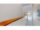 Well-lit hallway with wood railing leading to a beautiful view of the water at 12132 Capri S Cir, Treasure Island, FL 33706
