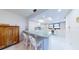 Well-lit kitchen with breakfast bar, white cabinetry, and a delightful floral backsplash at 12132 Capri S Cir, Treasure Island, FL 33706