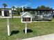 Little Free Library stand with books and bus stop nearby, fostering reading and convenience at 12132 Capri S Cir, Treasure Island, FL 33706