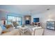 Inviting living room with stone fireplace, comfortable seating, and a view of the waterfront at 12132 Capri S Cir, Treasure Island, FL 33706