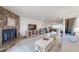 Open concept living room featuring a stone fireplace, flat screen television and easy access to kitchen at 12132 Capri S Cir, Treasure Island, FL 33706