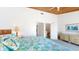 View of main bedroom with wooden ceiling and access to bathroom and stairs at 12132 Capri S Cir, Treasure Island, FL 33706